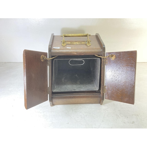 228A - An Edwardian oak coal scuttle with brass lever handle, two doors and tin liner - approx. 41cm high x... 