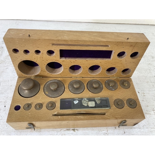 238 - A mid 20th century wooden cased set of brass graduating weights