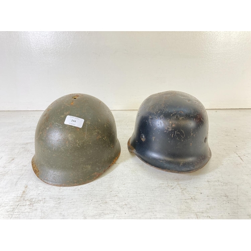 244 - Two vintage military helmets, one signed Patterson Walter Henrich and one M1