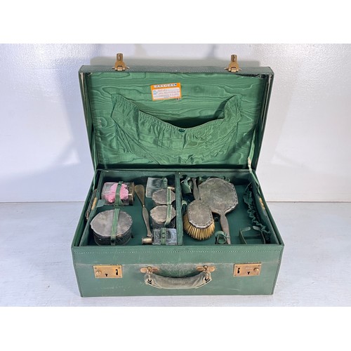 1240 - An M.I. Morris of Newport green leather travel case containing William Comyns & Sons Ltd hallmarked ... 