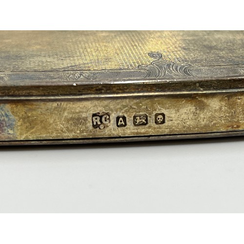 1240 - An M.I. Morris of Newport green leather travel case containing William Comyns & Sons Ltd hallmarked ... 