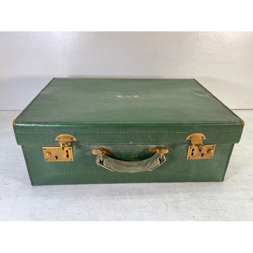 1240 - An M.I. Morris of Newport green leather travel case containing William Comyns & Sons Ltd hallmarked ... 