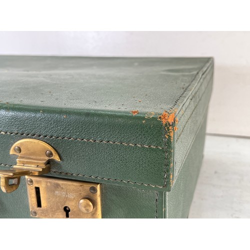 1240 - An M.I. Morris of Newport green leather travel case containing William Comyns & Sons Ltd hallmarked ... 