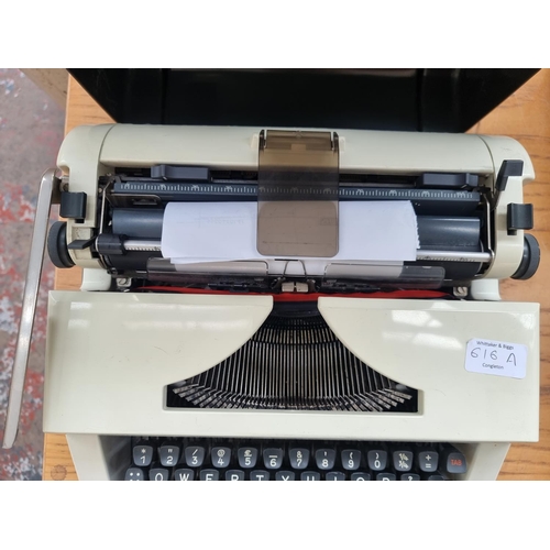 616A - A cased Olympia Monica S portable typewriter