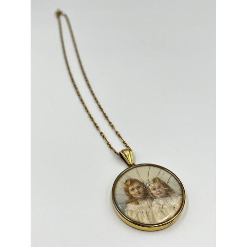 1051 - A late 19th/early 20th century 15ct gold photo locket pendant necklace with miniature hand painted p... 