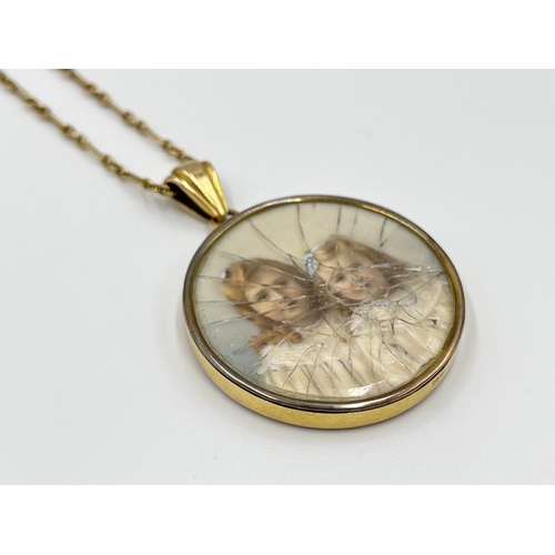 1051 - A late 19th/early 20th century 15ct gold photo locket pendant necklace with miniature hand painted p... 