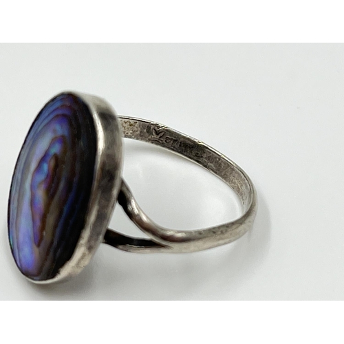 1056 - Four silver rings comprising oval abalone, .925 carnelian, and two .925 CZ stone - approx. gross wei... 