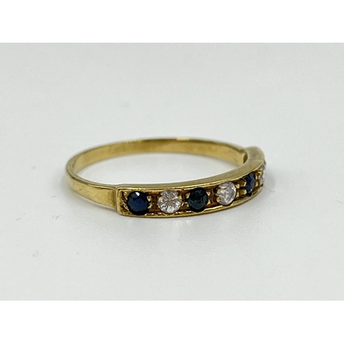 1064 - A hallmarked Birmingham 9ct gold CZ stone and sapphire half eternity ring, size N½ - approx. gross w... 