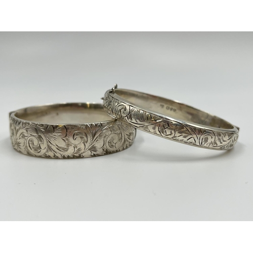 1067 - Two hallmarked sterling silver bangles with acanthus leaf design, one Joseph Smith & Sons Chester 19... 