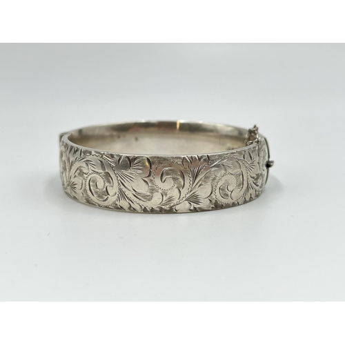 1067 - Two hallmarked sterling silver bangles with acanthus leaf design, one Joseph Smith & Sons Chester 19... 