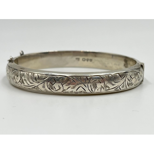 1067 - Two hallmarked sterling silver bangles with acanthus leaf design, one Joseph Smith & Sons Chester 19... 