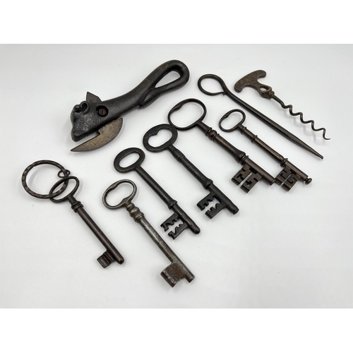 1107 - Nine Victorian metal collectables comprising six keys, one novelty bull can opener, one Improved cor... 