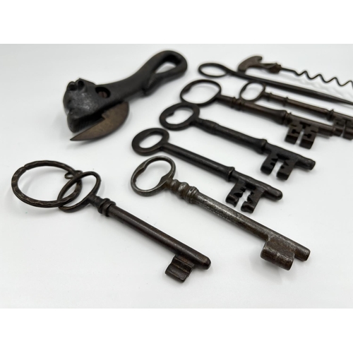 1107 - Nine Victorian metal collectables comprising six keys, one novelty bull can opener, one Improved cor... 