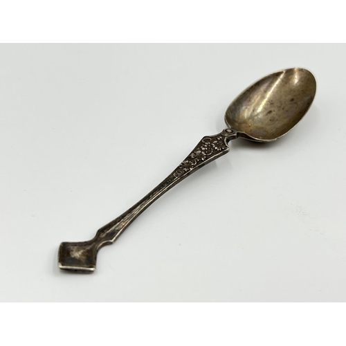 1201 - Four pieces of hallmarked silver and white metal comprising George V Sheffield silver tea spoon date... 