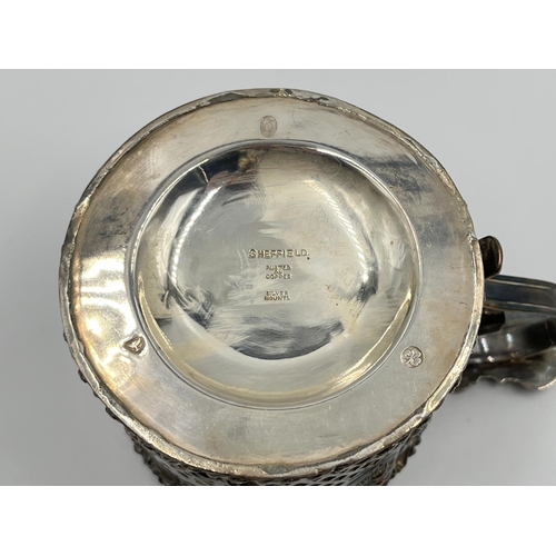 1202 - Two items, one George V hallmarked Birmingham silver and glass 15cm wine bottle coaster - dated 1933... 