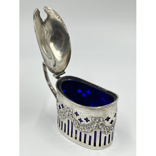 1220 - A William Aitkin Edward VII hallmarked Birmingham silver mustard pot with blue glass liner, dated 19... 