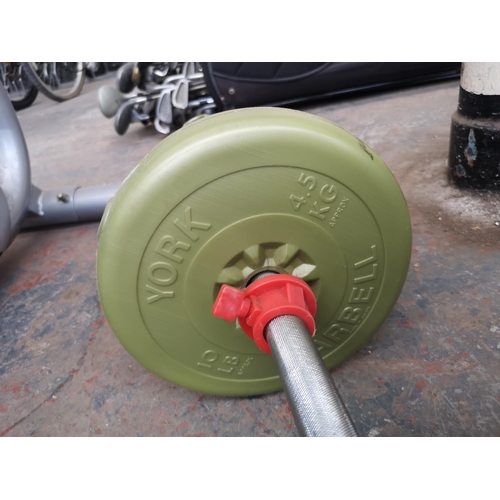 644 - Two pieces of exercise equipment, one dumbbell and one barbell with various York weights