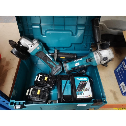 679 - Two cased Makita cordless grinding wheels with two batteries and charger