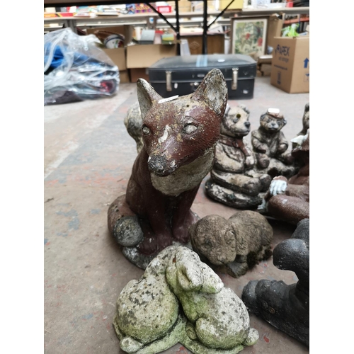 707 - A collection of cast stone animal garden ornaments to include fox, bears, squirrels etc.