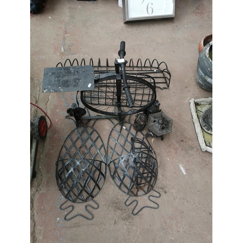 719 - A collection of wrought and cast iron garden items to include hanging basket, Art Nouveau style lant... 