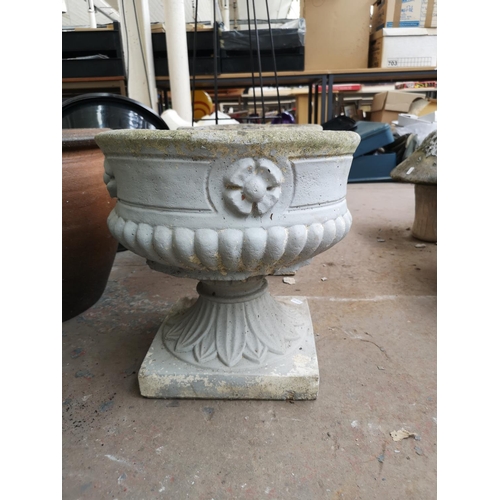 722 - Three cast stone garden items, two planters on pedestal base and one figural lady