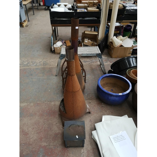 725 - Five items to include two chimeneas, outdoor candle lantern etc.