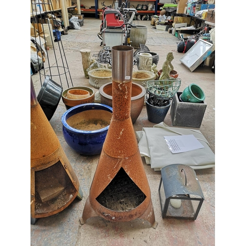 725 - Five items to include two chimeneas, outdoor candle lantern etc.