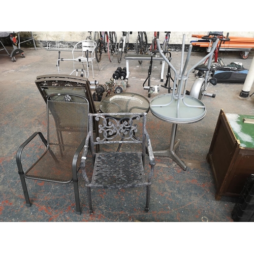 732 - Seven pieces of garden furniture comprising three circular tables and four armchairs