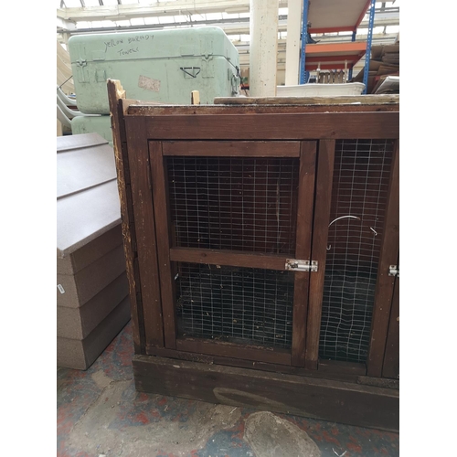 733 - Two items, one wooden rabbit hutch - approx. 76cm high x 118cm long x 60cm deep and one plastic dog ... 