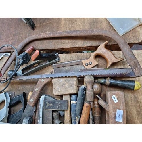 681 - A collection of assorted tools to include saws, wood planes, spirit levels, wood chisels etc.