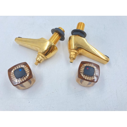 705A - Four pairs of various brass effect taps to include Waterworks etc.