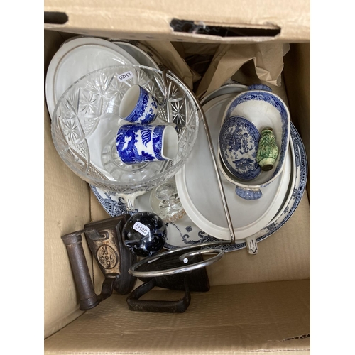 748 - Four boxes containing glass paperweights, antique flat irons, glass bowl, tray, metal detector, lawn... 