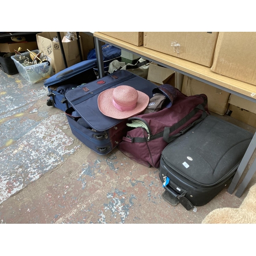 750 - Four items of luggage, two suitcases containing assorted clothing and two containing table linen