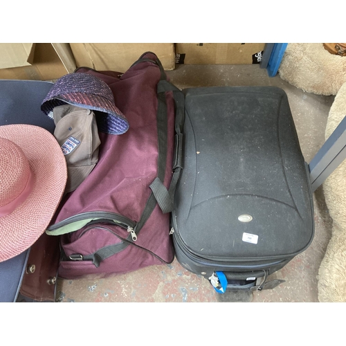 750 - Four items of luggage, two suitcases containing assorted clothing and two containing table linen