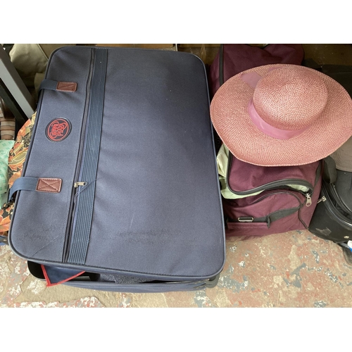 750 - Four items of luggage, two suitcases containing assorted clothing and two containing table linen