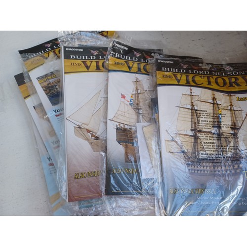 779 - A box containing a large quantity of Build Lord Nelson's HMS Victory magazines and model parts