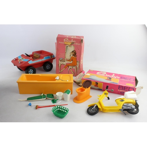 145 - A collection of vintage Sindy accessories to include buggy, moped, bath etc.