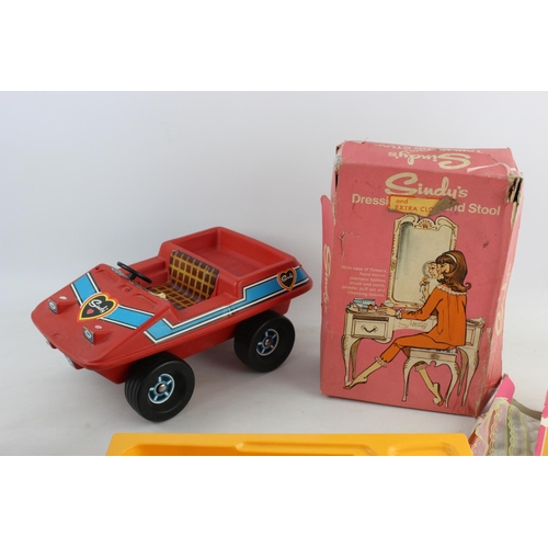 145 - A collection of vintage Sindy accessories to include buggy, moped, bath etc.