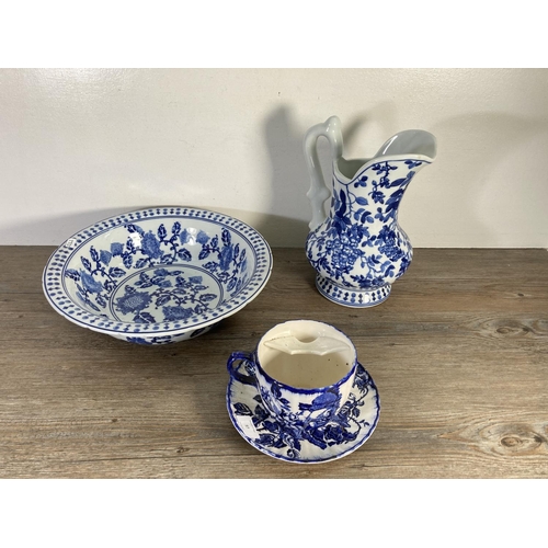 97 - Four pieces of blue and white china, Victoria Ironstone oversized cup and saucer with moustache guar... 