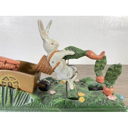 122 - A painted cast iron novelty bunnies mechanical money box - approx. 15cm high x 21cm wide x 7cm deep