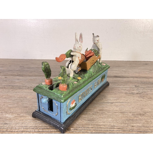 122 - A painted cast iron novelty bunnies mechanical money box - approx. 15cm high x 21cm wide x 7cm deep