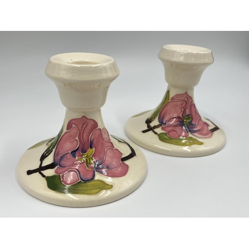 10 - A pair of Moorcroft Pottery Pink Magnolia pattern candlesticks - approx. 8.5cm high x 10cm diameter