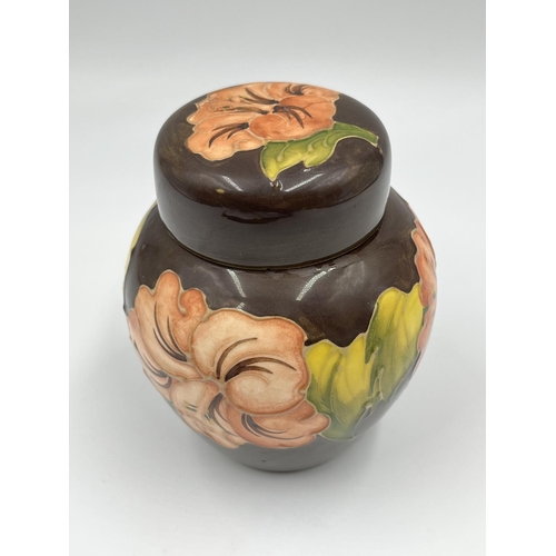 16 - A Moorcroft Pottery Coral Hibiscus pattern jar and cover - approx. 10.5cm high