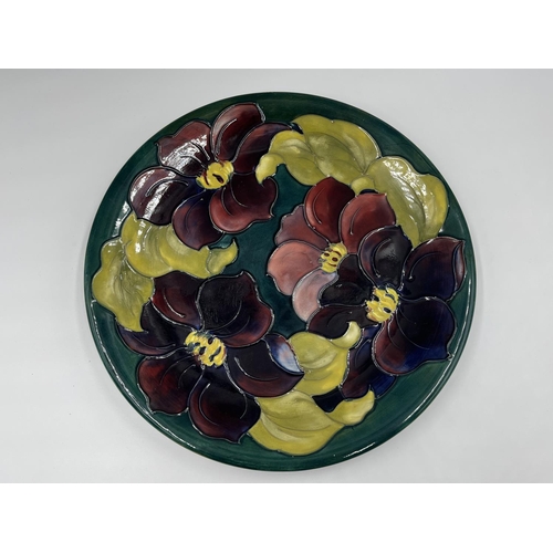 17 - A Moorcroft Pottery Clematis pattern plate - approx. 26cm diameter