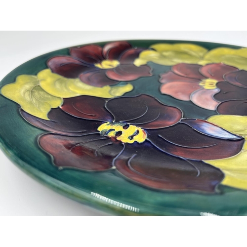 17 - A Moorcroft Pottery Clematis pattern plate - approx. 26cm diameter