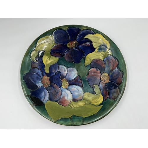 18 - A Moorcroft Pottery Clematis pattern plate - approx. 26cm diameter