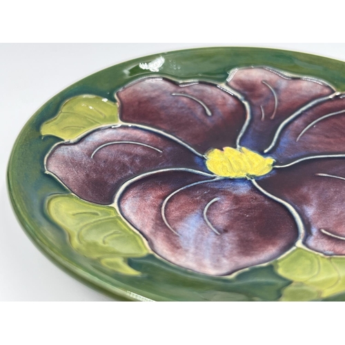 21 - A Moorcroft Pottery Clematis pattern circular trinket dish - approx. 11.5cm diameter