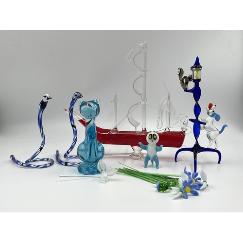 28 - A collection of studio glass to include cat figurine, dog chasing cat up lamppost figurine, flowers ... 