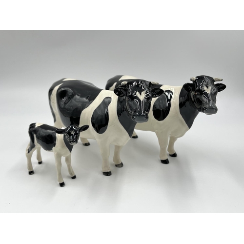 36 - Three Beswick Fresian Cattle figurines, Ch. Claybury Leegwater bull, Ch. Claybury Leegwater cow and ... 