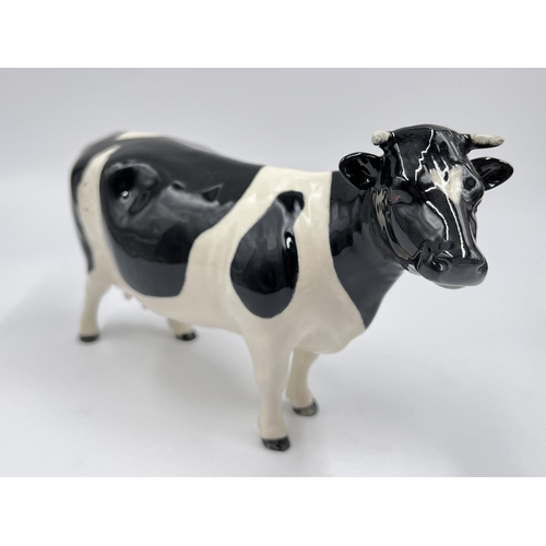 36 - Three Beswick Fresian Cattle figurines, Ch. Claybury Leegwater bull, Ch. Claybury Leegwater cow and ... 